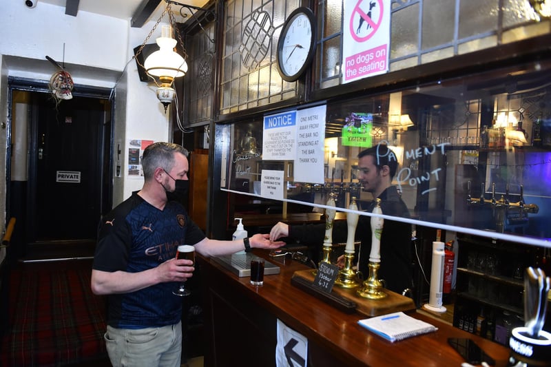 A man buys a drink at The Swan Inn. (Photo by Nathan Stirk/Getty Images)