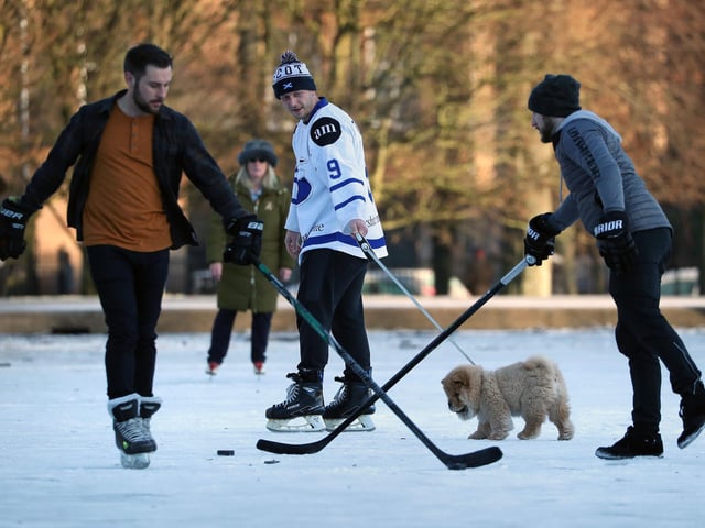 A person walks their dog on a frozen pond in Queen's Park in Glasgow . Picture: Andrew Milligan/PA Wire