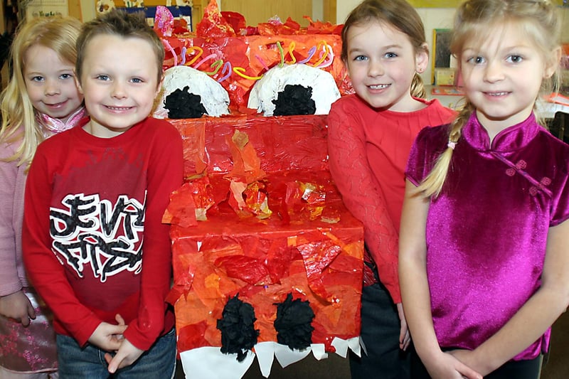 Charlotte Oxley, Connor Gregory, Caitlin South, Gemma Barthorpe with a Chinese dragon at Whitecotes School, Chesterfield.