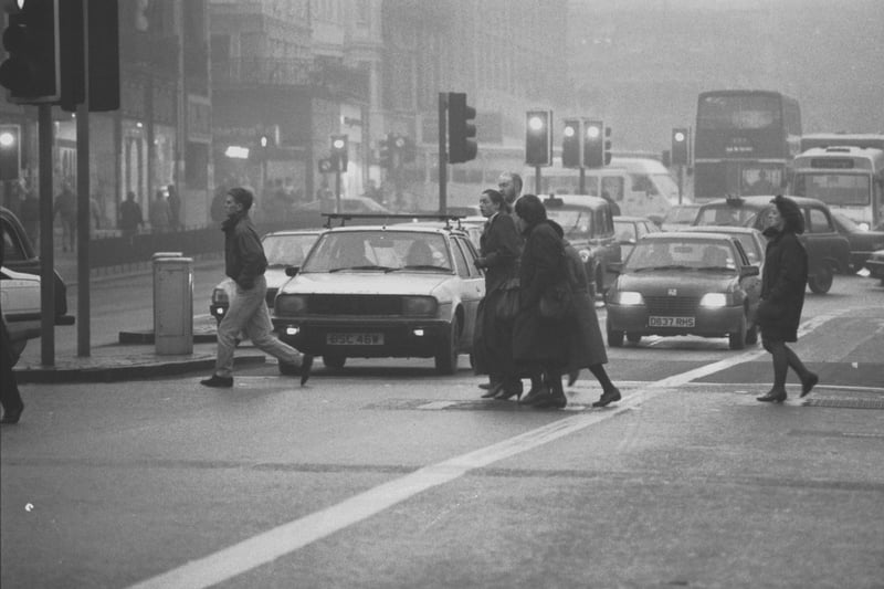 Fog causes problems for cars and pedestrians in Edinburgh's Princes Street in December 1989.