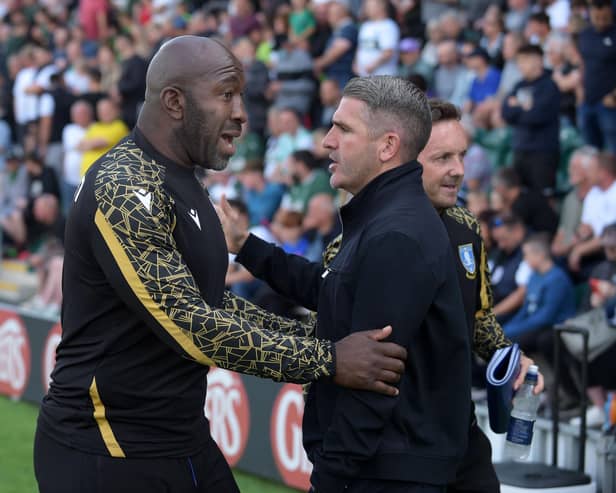 Sheffield Wednesday manager Darren Moore greets Ryan Lowe of Plymouth Argyle. Photo: Steve Ellis
