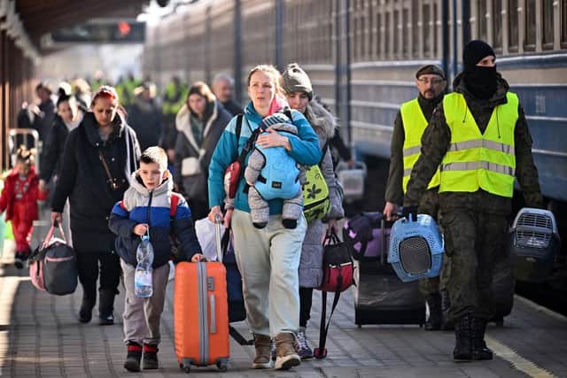 PRZEMYSL, POLAND - MARCH 21: People, mainly women and children, arrive at Przemysl train station on a train from Odesa in war-torn Ukraine on March 21, 2022 in Przemysl, Poland. Nearly two-thirds of the more than 3 million people to have fled Ukraine since Russia's invasion last month have come to Poland, which shares a 310-mile border with its eastern neighbor. (Photo by Jeff J Mitchell/Getty Images)