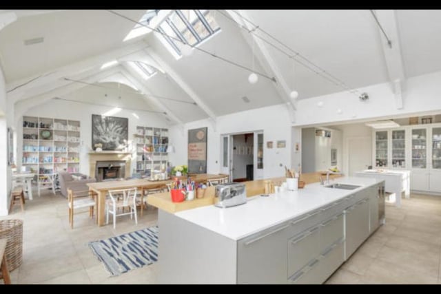 The spacious open plan kitchen / dining / family room is filled with lots of natural light giving it an from the double-height cathedral style ceiling and multi-aspect and skylight windows.There is also underfloor heating and a wood-burning stove.