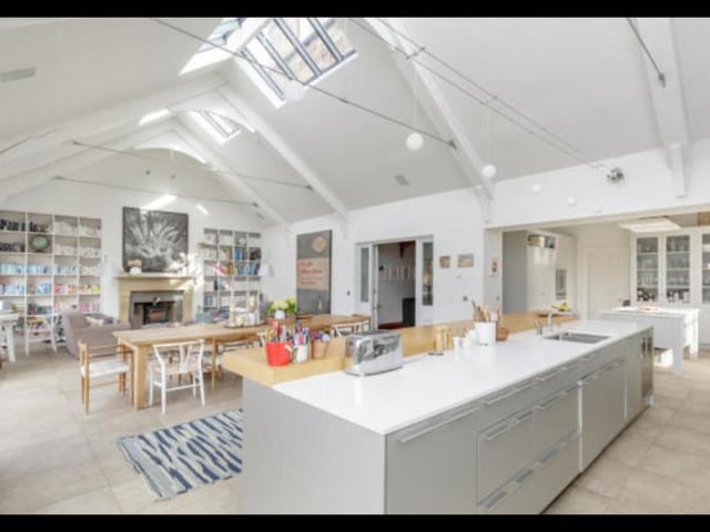 The spacious open plan kitchen / dining / family room is filled with lots of natural light giving it an from the double-height cathedral style ceiling and multi-aspect and skylight windows.There is also underfloor heating and a wood-burning stove.