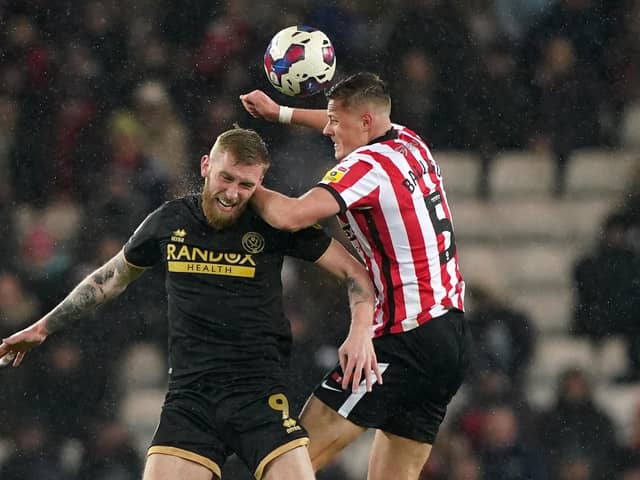 Sheffield United's Oli McBurnie (left) and Sunderland's Daniel Ballard battle for the ball during the Sky Bet Championship match at the Stadium of Light: Owen Humphreys/PA Wire.