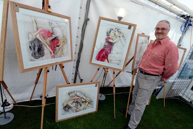 Artist Simon Richards with his creations shown at the 2013 show