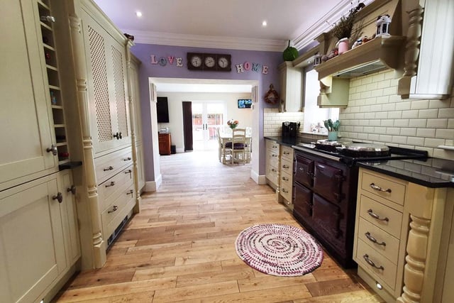 The kitchen area has an Aga, integrated fridge freezer and a larder