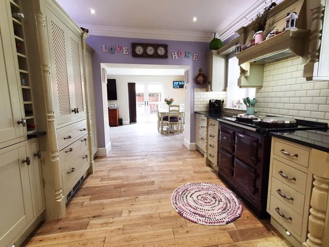 The kitchen area has an Aga, integrated fridge freezer and a larder