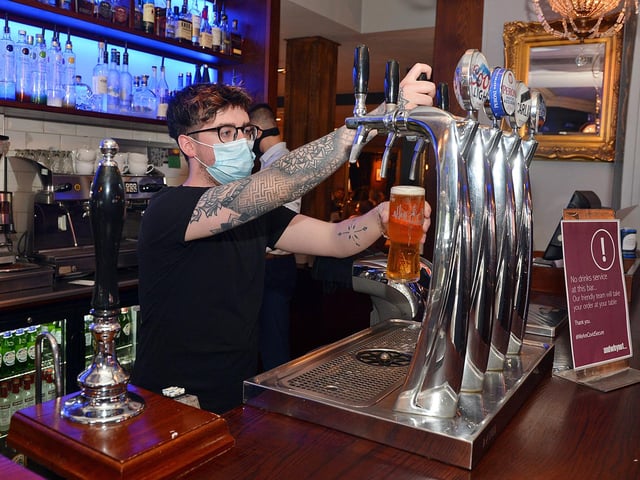 Tom Battle pulling a pint.