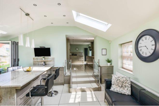 Bifold doors combined with traditional and ceiling windows, give this space so much natural light.
