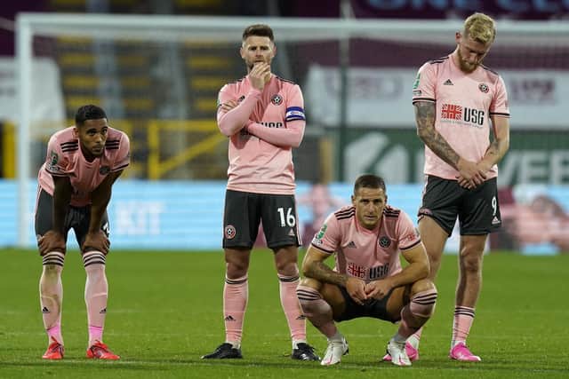 Oli McBurnie of Sheffield Utd (R) reacts after missing a penalty during the Carabao Cup match at Turf Moor, Burnley.  Andrew Yates/Sportimage
