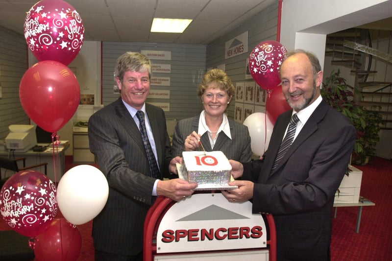 Pictured at Spencers Estate Agents, Ecclesall Road, Sheffield in 2003, where the 10th anniversary of their opening was being celebrated. Seen LtoR are, Jim Spencer ,  Anne Spencer, and  Geoff Ackroyd,  as the cake is cut.