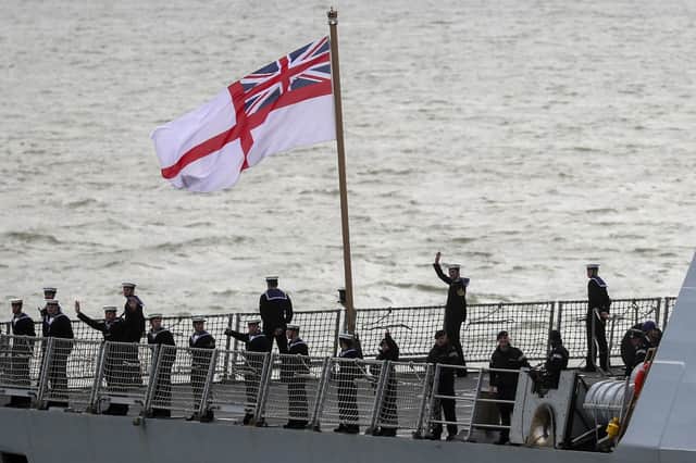 The ship's company of HMS Dragon wave to friends and family as she returns to Portsmouth Picture: Steve Parsons/PA Wire