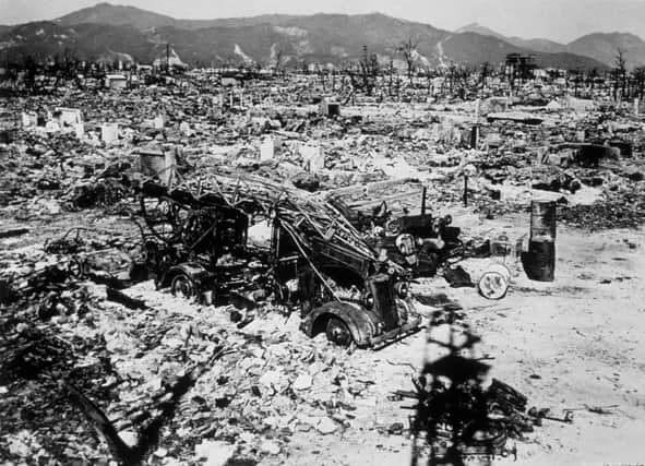 Atomic bomb damage at Hiroshima in 1945 with a burnt out fire engine amid the rubble