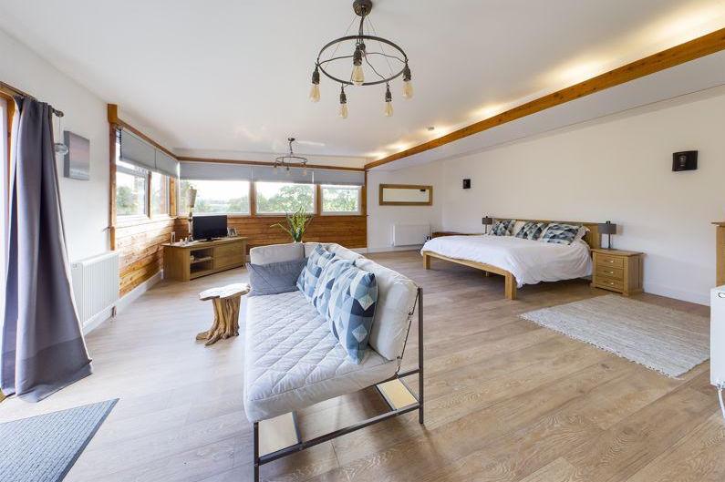 A recent extension helped to create this huge master bedroom, with its own walk-in dressing room, integrated wardrobes and a beautifully stylish en-suite bathroom.