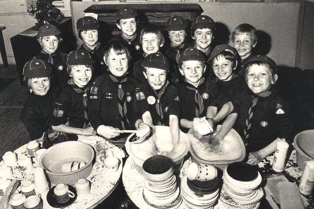 The 74th Sheffield (Heeley) Cub Scouts buckle down to a sponsored dish washing session at Heeley Parish Church Hall in 1979