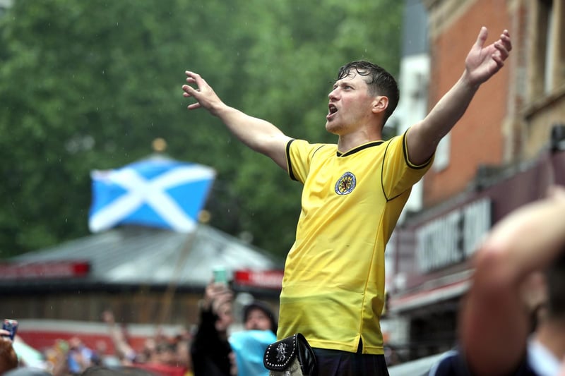 One Scotland fan seen cheering on his side above the crowds with a saltire flying appropriately behind him in Leicester Square (Photo: Kieran Cleeves/ PA Wire).
