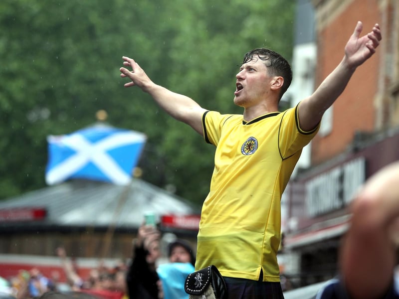One Scotland fan seen cheering on his side above the crowds with a saltire flying appropriately behind him in Leicester Square (Photo: Kieran Cleeves/ PA Wire).