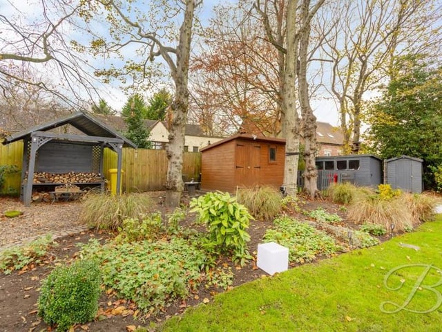 The well-established garden at the back of the property is a lovely area, thanks particularly to its mature trees. Surrounded by fencing, it gives a degree of privacy too.