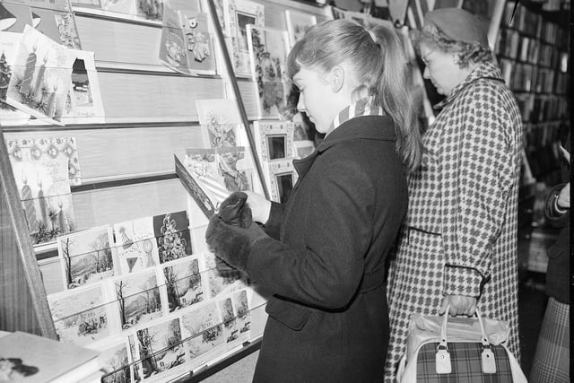 A woman Christmas card shopping in Edinburgh City Centre in 1959.