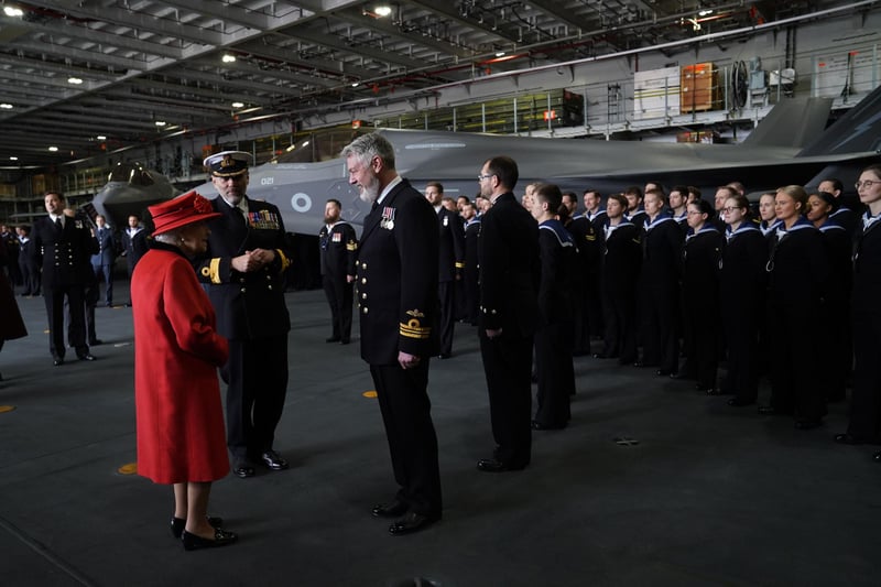 Queen Elizabeth II meeting personnel during a visit to HMS Queen Elizabeth at HM Naval Base, Portsmouth, ahead of the ship's maiden deployment. The visit comes as HMS Queen Elizabeth prepares to lead the UK Carrier Strike Group on a 28-week operational deployment travelling over 26,000 nautical miles from the Mediterranean to the Philippine Sea. Picture date: Saturday May 22, 2021. PA Photo. See PA story ROYAL Carrier. Photo credit should read: Steve Parsons/PA Wire