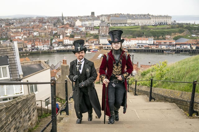 Two steampunks in top hats climb Whitby's 199 steps