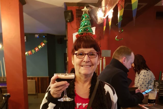 Judy England enjoying a festive drink.