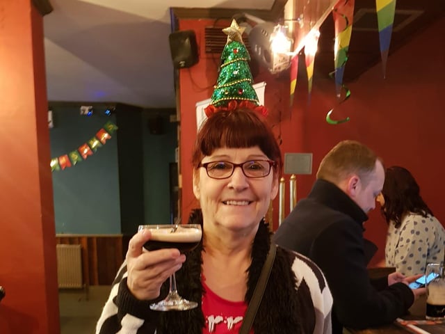 Judy England enjoying a festive drink.
