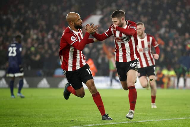 SHEFFIELD, ENGLAND - DECEMBER 26: Ollie Norwood of Sheffield United (R) celebrates after scoring his team's first goal from the penalty spot with David McGoldrick of Sheffield United during the Premier League match between Sheffield United and Watford FC at Bramall Lane on December 26, 2019 in Sheffield, United Kingdom. (Photo by Bryn Lennon/Getty Images)