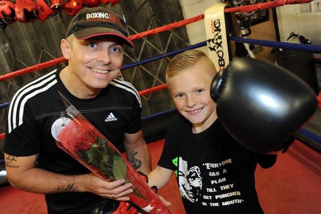 Eight year old Kian Bak, presents, Chris Boyle, the owner of X Boxing Academy with his Guardian Rose.
