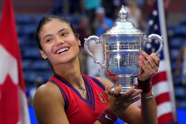 Britain's Emma Raducanu celebrates with the trophy after winning the 2021 US Open Tennis tournament women's final match against Canada's Leylah Fernandez at the USTA Billie Jean King National Tennis Center in New York (Photo by TIMOTHY A. CLARY/AFP via Getty Images)