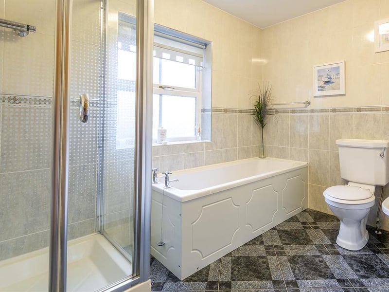 Complete with enclosed shower, panelled bath, low-flush WC, bidet and wash hand basin.