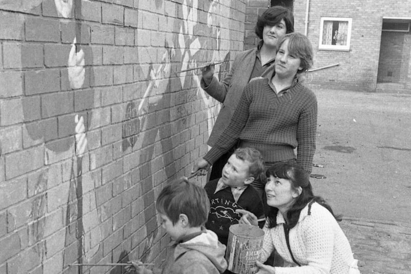 Painting a mural in Norman Court. Who can tell us more about this February 1980 scene?