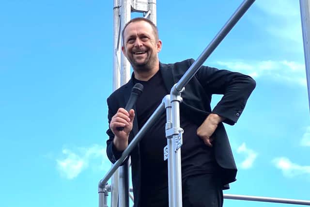 Comedian Tom Binns on The Bus Stop Arena stage - built on the top of his VW camper van