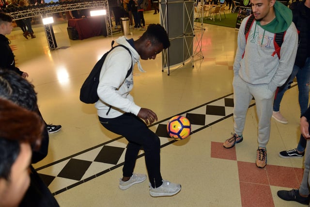 A student showing his football skills at the SAFC stand.