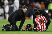 lliman Ndiaye of Sheffield United receives medical attention before making way against Stoke: Lexy Ilsley / Sportimage