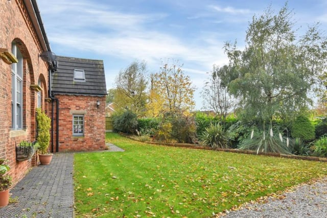 The front garden benefits from a lawned area with established borders, hedging and trees providing the privacy.