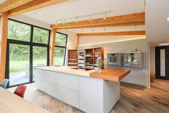 The open plan design incorporates a bespoke Bulthaup kitchen island with Gaggenau appliances.