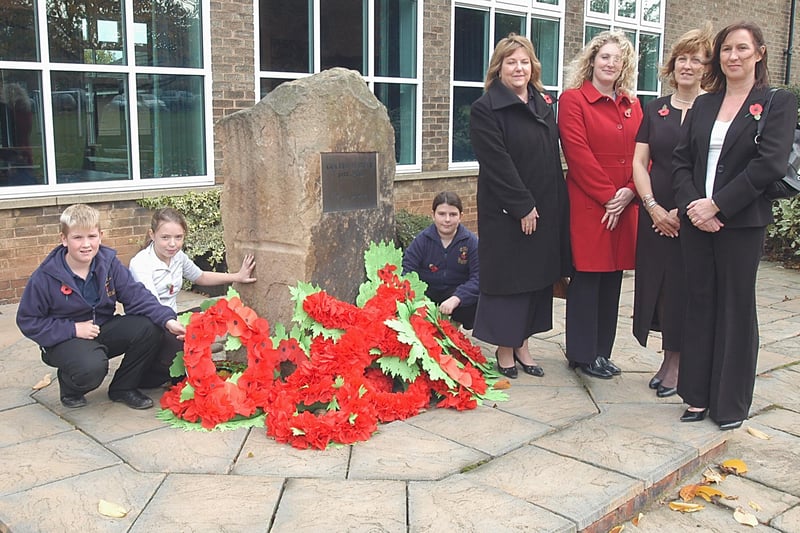 Pupils Kieran Hollingsworth, Natalie Colligan and Emily Wild are pictured with guests Jill Hanson and Helen Bradley, from the Mansfield branch of the Derbyshire Building Society, headteacher Mrs Davis and governor Julia Yemm at the school's remembrance service.