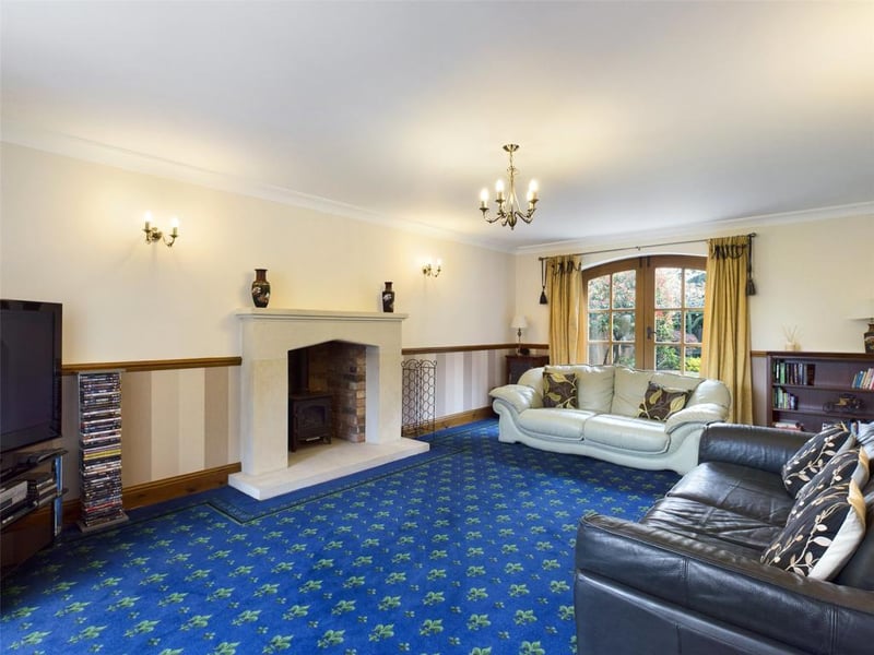 Lounge - with feature stone fireplace and raised hearth incorporating the gas burner, French style doors to the rear.