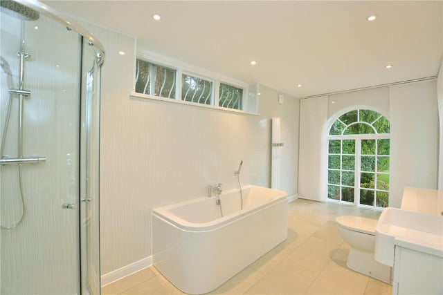 The master bedroom has its own stylish en-suite bathroom, complete with a bath and separate shower cubicle, while there is a further modern bathroom on the first floor.