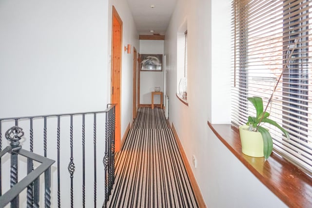 This bright corridor connects the upstairs bedrooms
