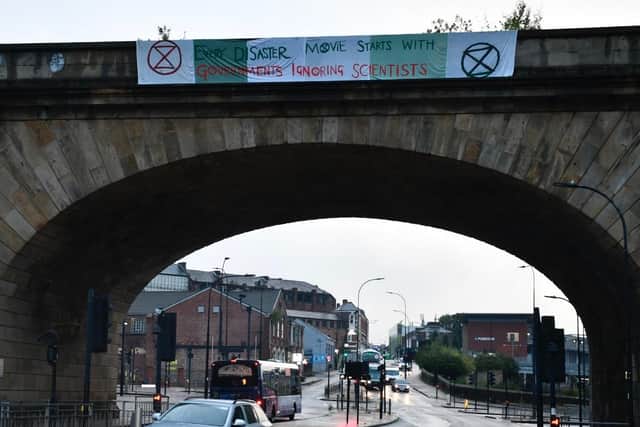 Protesters hung a banner over the Wicker Arches in Sheffield overnight, that reads 'every disaster movie starts with governments ignoring scientists'.