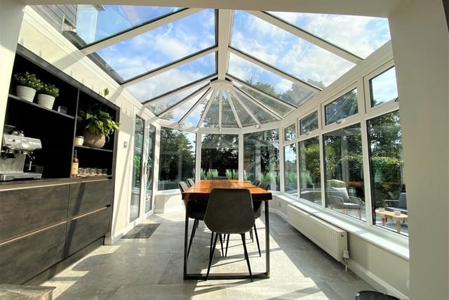 The dining room is located in this conservatory. Imagine eating lunch here with the sun shining overhead. Lovely.