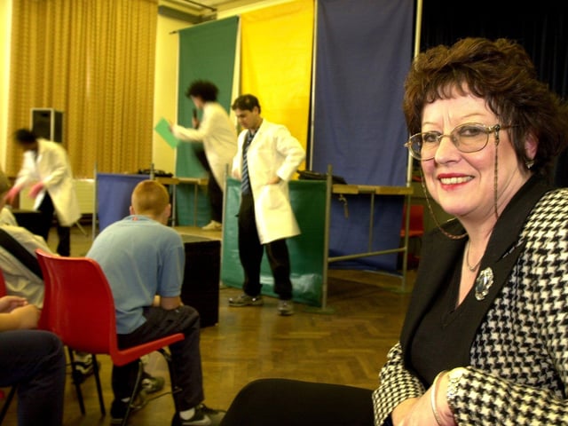 Mo Laycock, headteacher of Firth Park Community College, in Sheffield, with drama students in the background, in June 2001