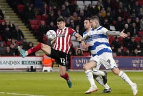 John Egan of Sheffield Utd with Lyndon Dykes of QPR during the Sky Bet Championship match at Bramall Lane. Picture:  Andrew Yates / Sportimage