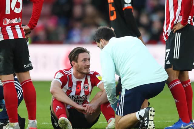 Ben Davies receives treatment for an injury during Sheffield United's game against Blackpool: Simon Bellis/ Sportimage