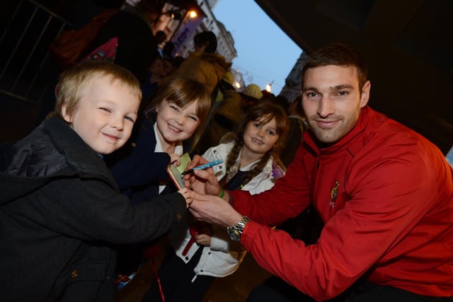 Jamie McCombe signs autographs at the Doncaster Christmas lights switch on with Paul-Lewis Cassidy, five, sisters Cleo Cassidy, six, and Skye Cassidy, seven, all of Carcroft.