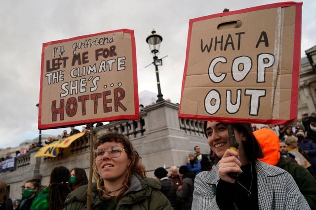 A pair of London-based protesters opt for humour with their placards (Getty Images)