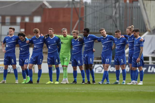 Hartlepool United's players observe a minute silence in remembrance of Lee Collins of Yeovil who died earlier in this week  during the Vanarama National League match between Hartlepool United and Dagenham and Redbridge at Victoria Park, Hartlepool on Friday 2nd April 2021. (Credit: Mark Fletcher | MI News)